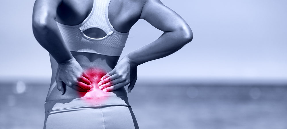 Back pain. Athletic running woman with back injury How it works